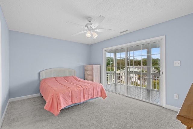 carpeted bedroom featuring access to exterior, baseboards, ceiling fan, and a textured ceiling
