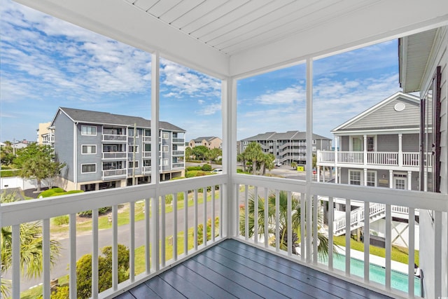 unfurnished sunroom with healthy amount of natural light and a residential view