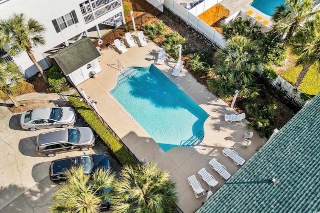 community pool featuring a patio and fence