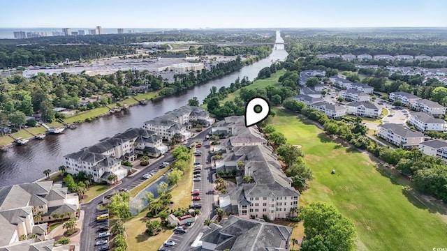 view of property location featuring a large body of water and nearby suburban area