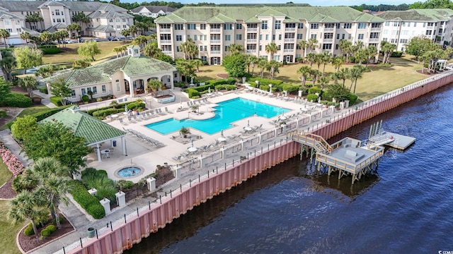 community pool featuring a water view and a patio area