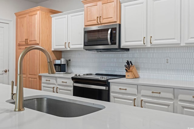 kitchen featuring electric stove, stainless steel microwave, and light countertops