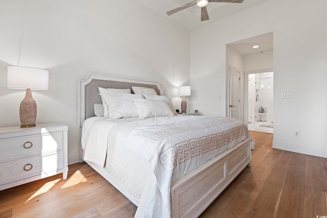 bedroom with wood-type flooring, a ceiling fan, and baseboards
