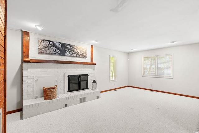 1314 Holly Dr, North Myrtle Beach, SC 29582 - unfurnished living room featuring a brick fireplace, carpet floors, and baseboards