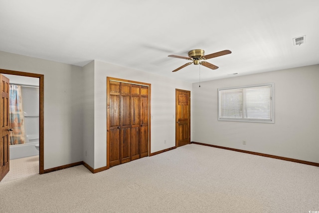 1314 Holly Dr, North Myrtle Beach, SC 29582 - unfurnished bedroom with baseboards, light carpet, ceiling fan, and connected bathroom