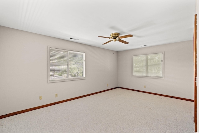1314 Holly Dr, North Myrtle Beach, SC 29582 - unfurnished room featuring healthy amount of natural light, ceiling fan, carpet floors, and baseboards