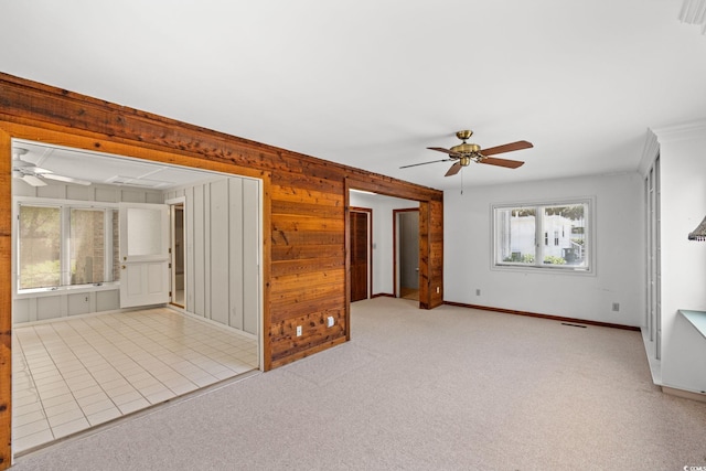 1314 Holly Dr, North Myrtle Beach, SC 29582 - carpeted empty room featuring ceiling fan, healthy amount of natural light, wood walls, and baseboards
