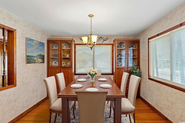 1314 Holly Dr, North Myrtle Beach, SC 29582 - dining area with light wood-style flooring, a chandelier, healthy amount of natural light, and wallpapered walls