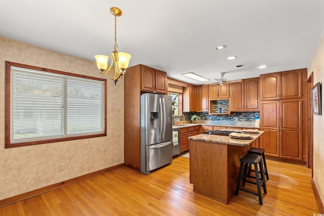 1314 Holly Dr, North Myrtle Beach, SC 29582 - kitchen featuring stainless steel appliances, light wood-style flooring, baseboards, brown cabinetry, and recessed lighting