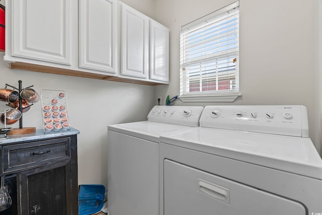 laundry room with washing machine and dryer and cabinet space