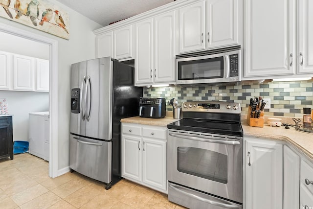 kitchen with appliances with stainless steel finishes, white cabinets, light countertops, backsplash, and a textured ceiling