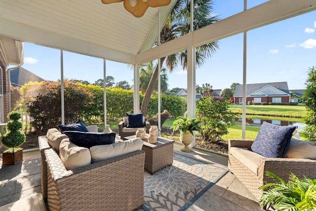 sunroom featuring an outdoor hangout area, a water view, a ceiling fan, and vaulted ceiling