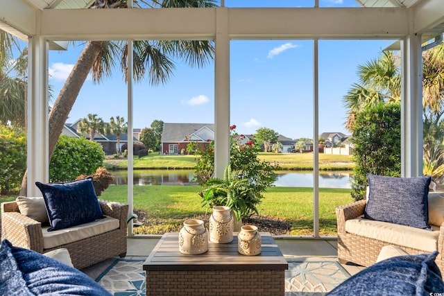 sunroom / solarium featuring a water view, an outdoor hangout area, and a residential view