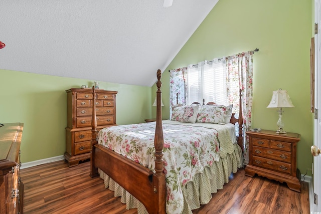 bedroom featuring vaulted ceiling, wood finished floors, baseboards, and ceiling fan