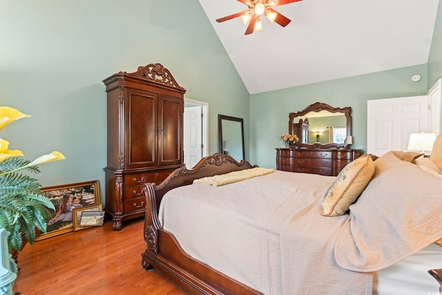 bedroom featuring high vaulted ceiling, light wood finished floors, and a ceiling fan