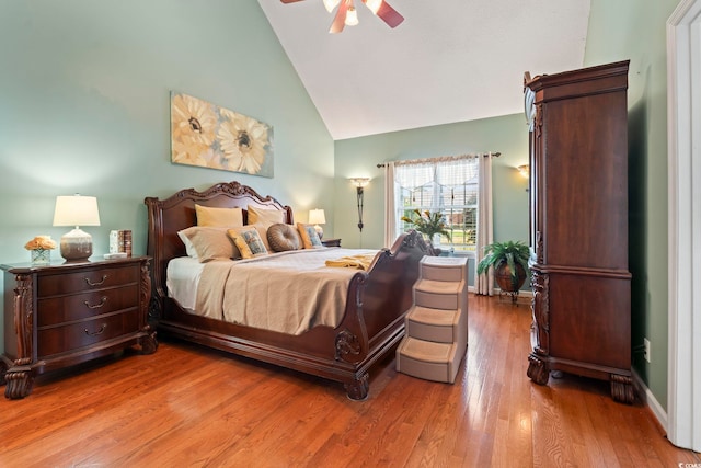 bedroom with high vaulted ceiling, light wood-style flooring, and ceiling fan