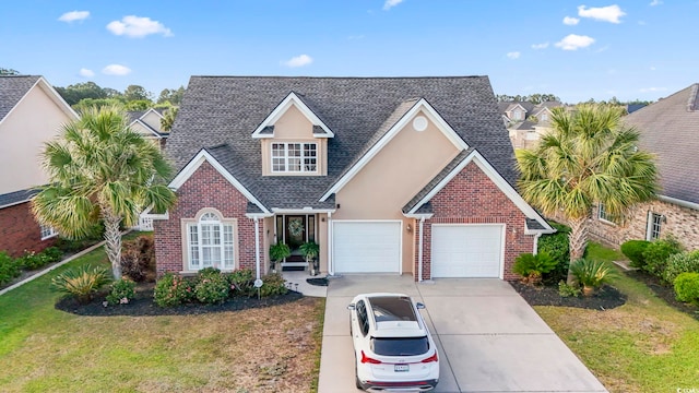 traditional-style house featuring driveway, brick siding, roof with shingles, and a front yard