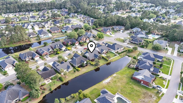 aerial overview of property's location with nearby suburban area and a large body of water