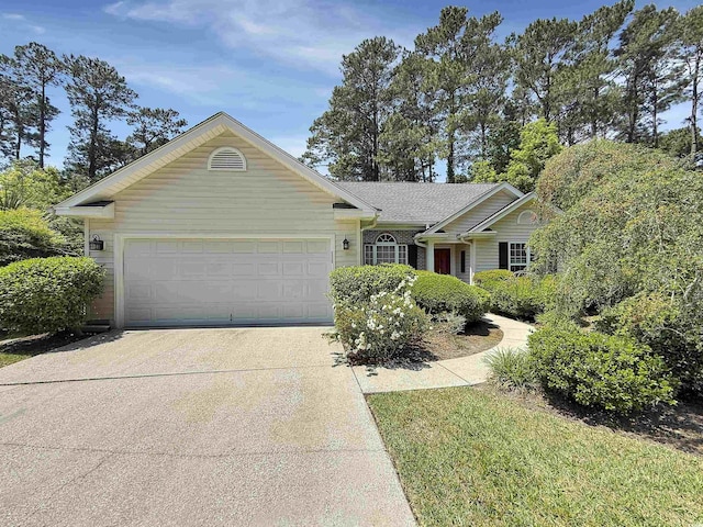 single story home with driveway and a garage