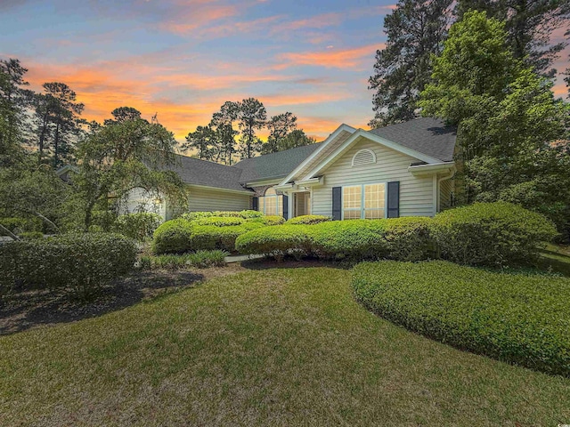 ranch-style house with a front lawn