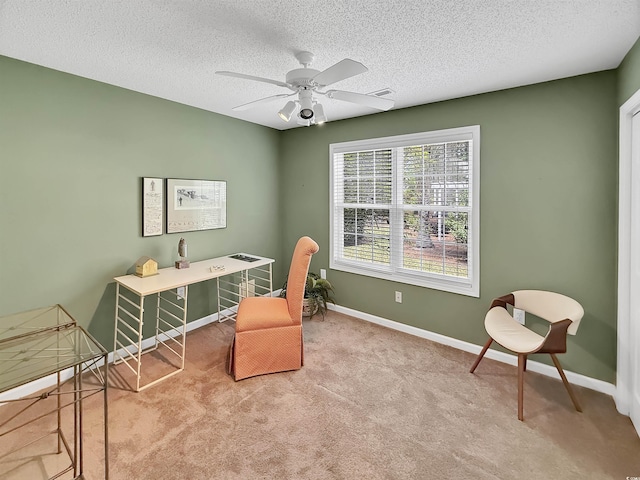 carpeted office featuring a ceiling fan, baseboards, and a textured ceiling