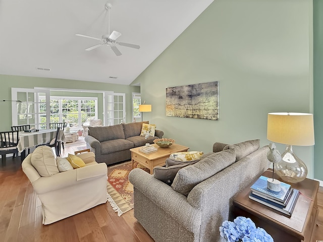 living room featuring ceiling fan, wood finished floors, and high vaulted ceiling
