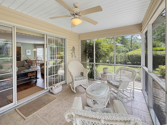 sunroom / solarium with a ceiling fan and plenty of natural light