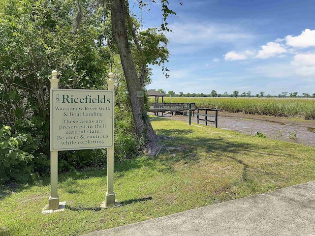 surrounding community with a yard and a view of countryside