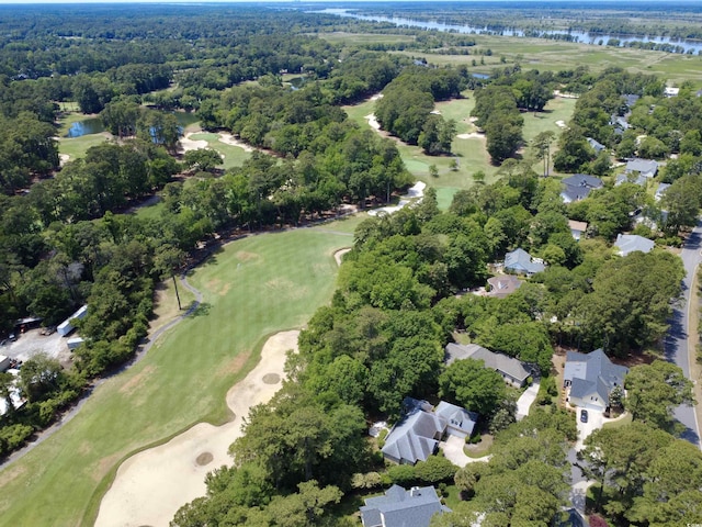 aerial view of property's location featuring a large body of water, a local golf course, and nearby suburban area