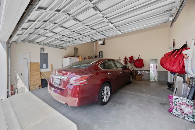 garage with a garage door opener and electric panel