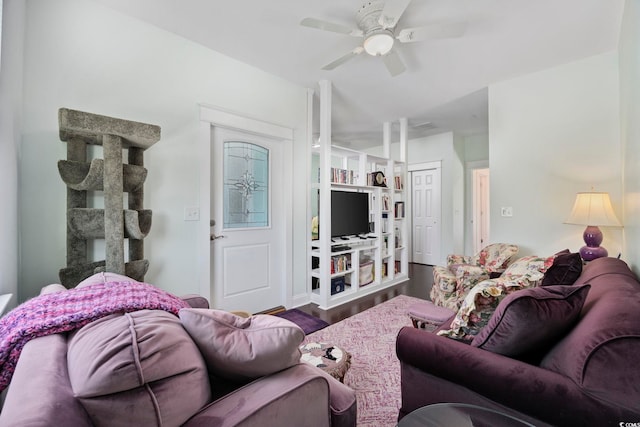 living area with a ceiling fan and wood finished floors