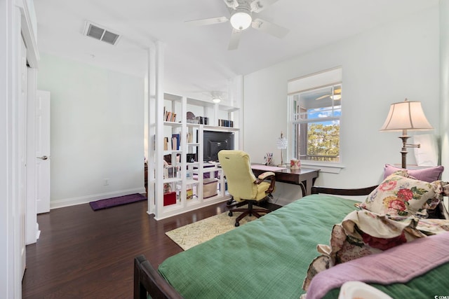 bedroom with wood finished floors, baseboards, a ceiling fan, and an office area