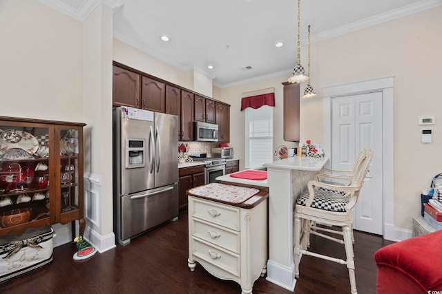 kitchen featuring appliances with stainless steel finishes, light countertops, dark brown cabinets, dark wood-style floors, and ornamental molding