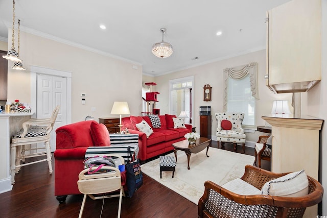living room with wood finished floors, ornamental molding, and recessed lighting
