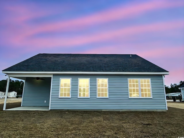 rear view of house featuring a ceiling fan, a patio, and a shingled roof