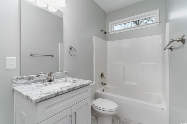 bathroom featuring toilet, vanity, and  shower combination