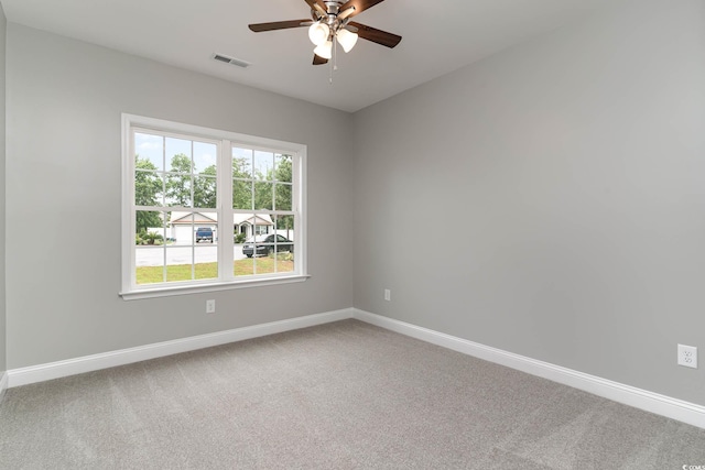 unfurnished room featuring ceiling fan, carpet, and baseboards