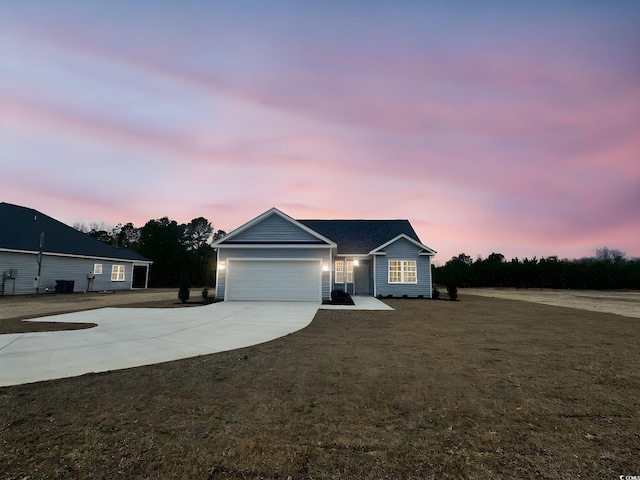 ranch-style house featuring concrete driveway and an attached garage