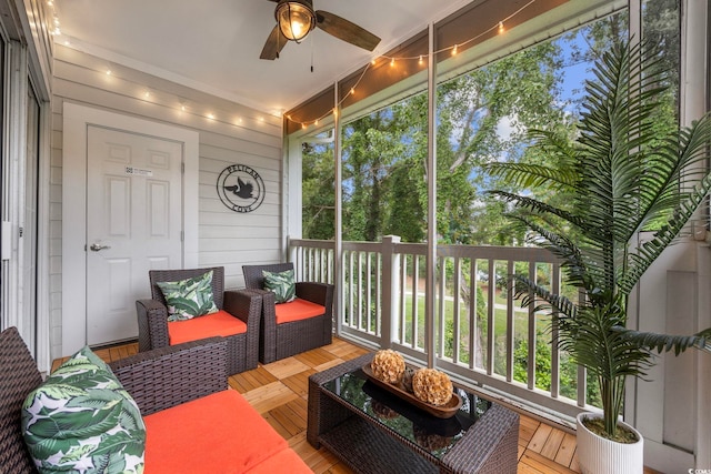 sunroom with a ceiling fan and plenty of natural light