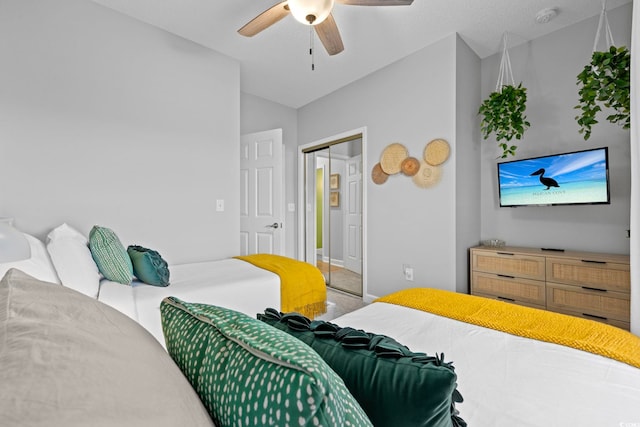 bedroom with a closet, baseboards, a ceiling fan, vaulted ceiling, and carpet flooring