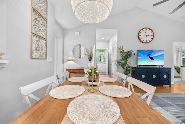 dining space with vaulted ceiling and wood finished floors