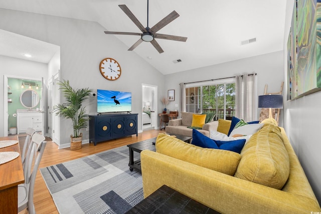 living room featuring ceiling fan, wood finished floors, and high vaulted ceiling