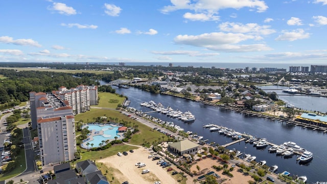 view of urban area with a nearby body of water, a marina, and a pool