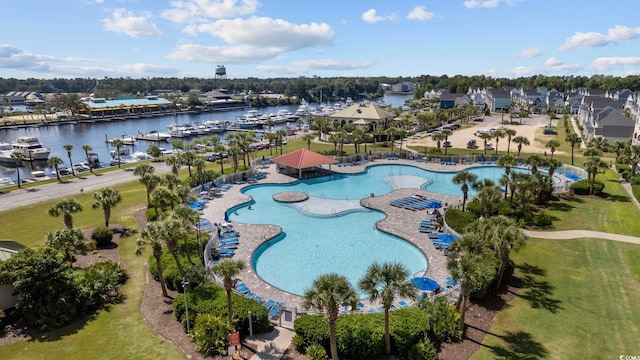 aerial view of property's location with a pool and a nearby body of water