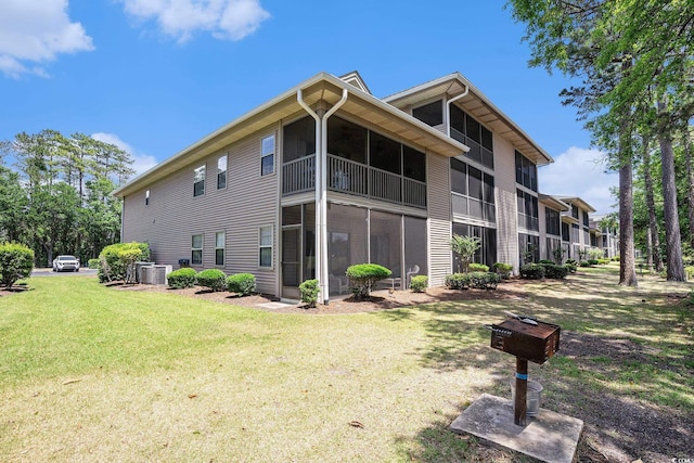 342 Pinehurst Ln Unit 12J, Pawleys Island, SC 29585 - view of side of property with a lawn, central AC unit, and a sunroom