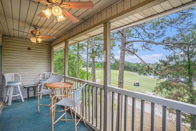 balcony featuring a ceiling fan and view of golf course