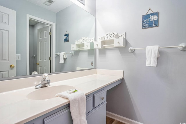 342 Pinehurst Ln Unit 12J, Pawleys Island, SC 29585 - bathroom with vanity, baseboards, and wood finished floors