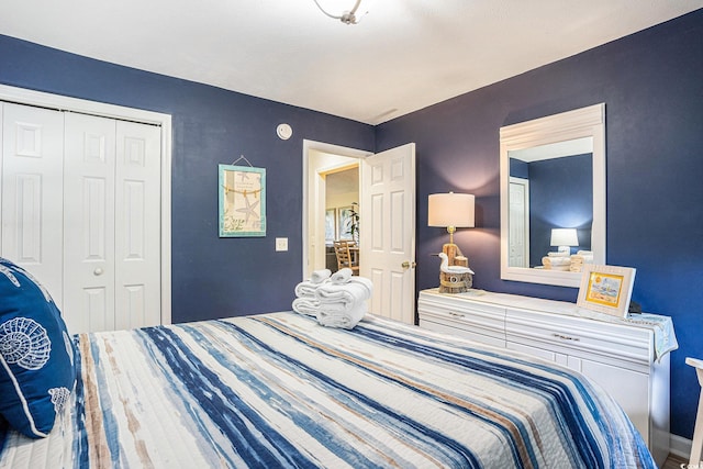 bedroom with a closet and baseboards