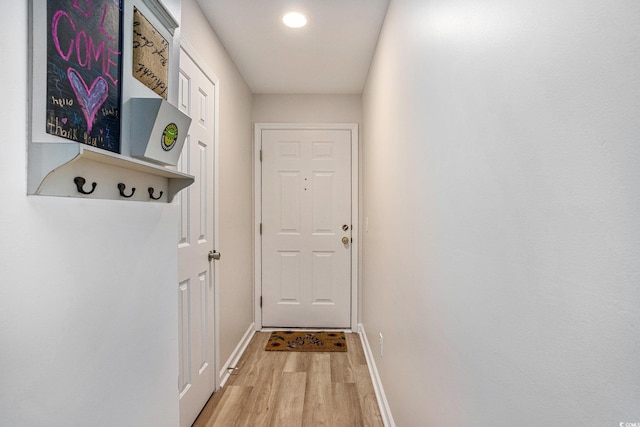 entryway featuring light wood-style flooring and baseboards