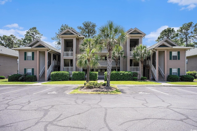 342 Pinehurst Ln Unit 12J, Pawleys Island, SC 29585 - view of property with stairs and uncovered parking